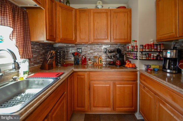 518 S Glenwood St, Allentown, PA 18104 - kitchen with a sink, tasteful backsplash, brown cabinetry, and light countertops