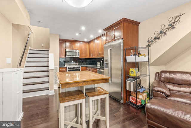 1522 Race St Unit 1, Philadelphia, PA 19102 - kitchen featuring stainless steel appliances, dark wood-style floors, open floor plan, backsplash, and a kitchen breakfast bar