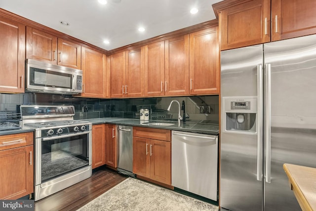 1522 Race St Unit 1, Philadelphia, PA 19102 - kitchen with appliances with stainless steel finishes, dark wood-style flooring, a sink, tasteful backsplash, and recessed lighting