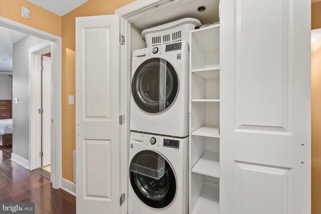 1522 Race St Unit 1, Philadelphia, PA 19102 - laundry area featuring stacked washer / drying machine, dark wood-style flooring, and baseboards