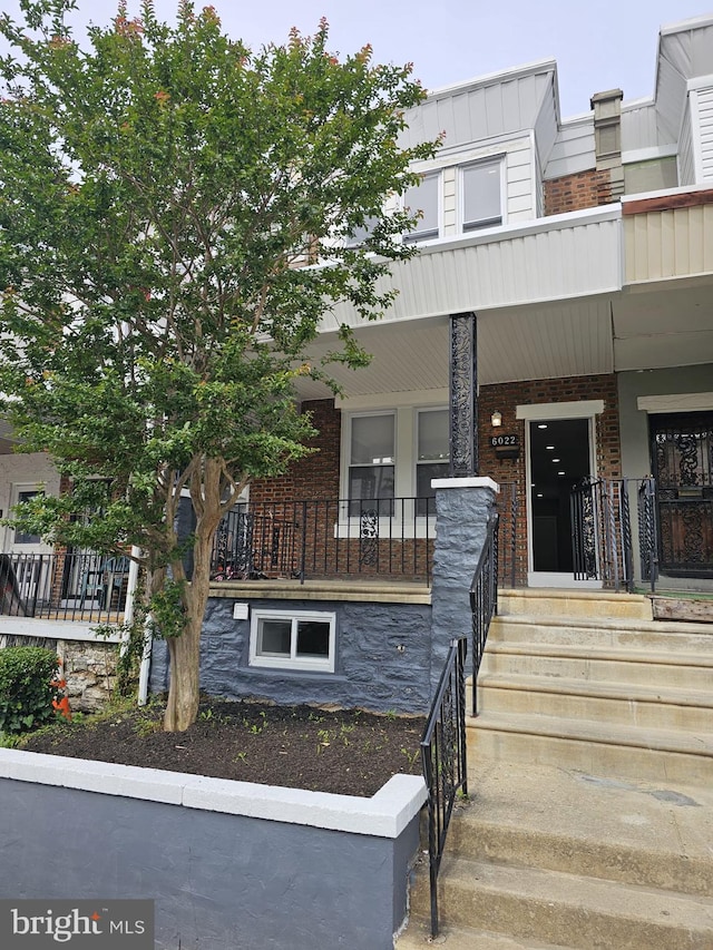6022 N Lambert St, Philadelphia, PA 19138 - townhome / multi-family property featuring brick siding, covered porch, and board and batten siding