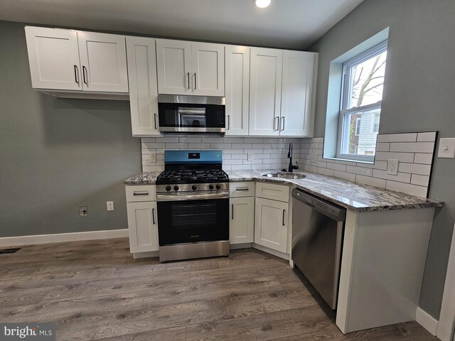 6022 N Lambert St, Philadelphia, PA 19138 - kitchen featuring stainless steel appliances, a sink, white cabinetry, and light stone countertops