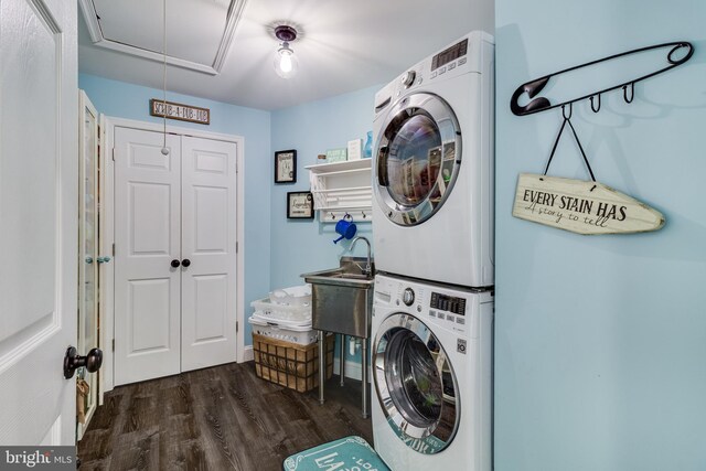 7001 Locust Ct, Owings, MD 20736 - laundry room with stacked washing machine and dryer, dark wood-type flooring, and attic access