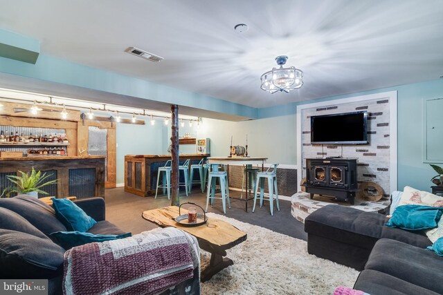 7001 Locust Ct, Owings, MD 20736 - living room with a dry bar, a wood stove, and baseboards