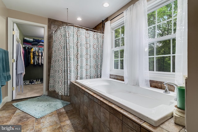 7001 Locust Ct, Owings, MD 20736 - bathroom with a garden tub, curtained shower, baseboards, recessed lighting, and stone finish floors
