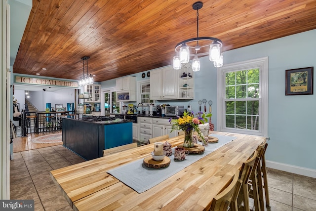 7001 Locust Ct, Owings, MD 20736 - dining area with wood ceiling, a chandelier, baseboards, tile patterned floors, and stairs
