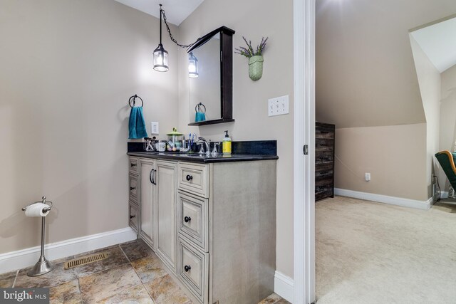 7001 Locust Ct, Owings, MD 20736 - bathroom featuring lofted ceiling, vanity, and baseboards