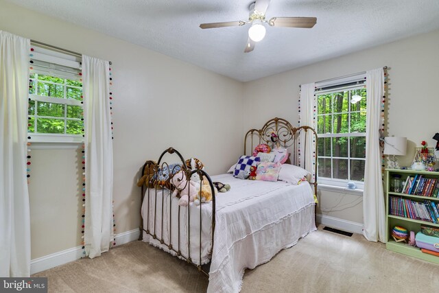 7001 Locust Ct, Owings, MD 20736 - carpeted bedroom with baseboards, ceiling fan, and a textured ceiling