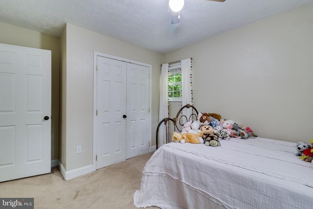 7001 Locust Ct, Owings, MD 20736 - bedroom featuring light colored carpet, a closet, a textured ceiling, baseboards, and ceiling fan