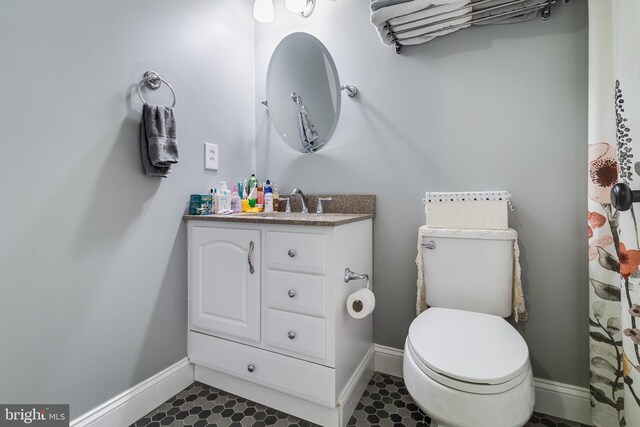 7001 Locust Ct, Owings, MD 20736 - bathroom with vanity, baseboards, and toilet