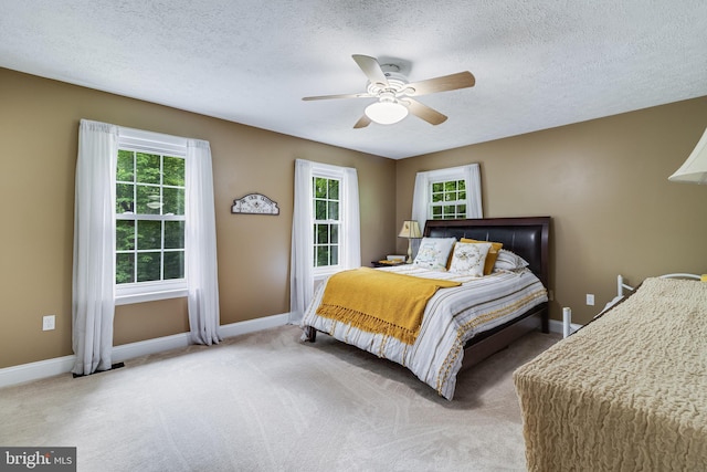 7001 Locust Ct, Owings, MD 20736 - bedroom with baseboards, carpet floors, a textured ceiling, and a ceiling fan