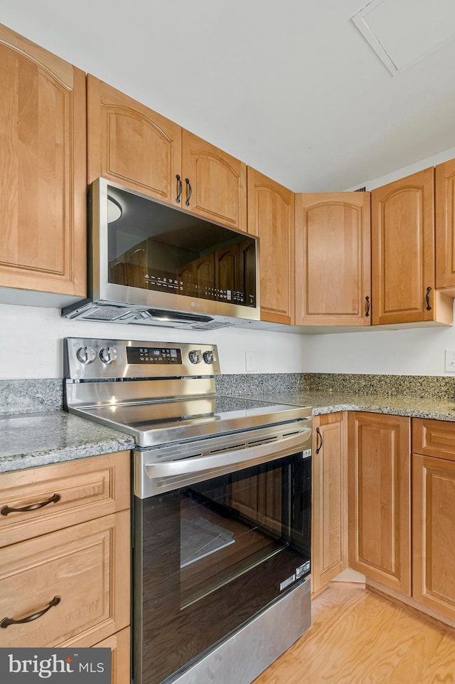 6800 Fleetwood Rd Unit 1219, Mclean, VA 22101 - kitchen featuring appliances with stainless steel finishes, light stone countertops, and light wood-style flooring