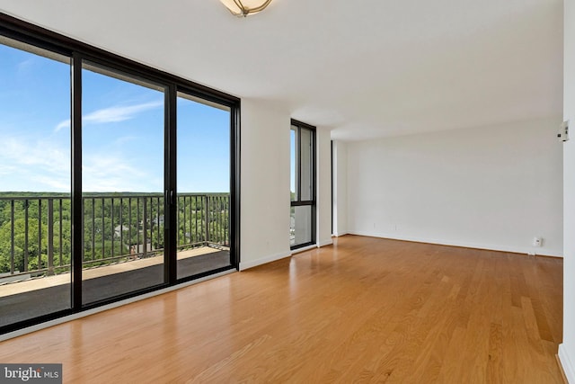 6800 Fleetwood Rd Unit 1219, Mclean, VA 22101 - empty room with expansive windows, wood finished floors, and baseboards