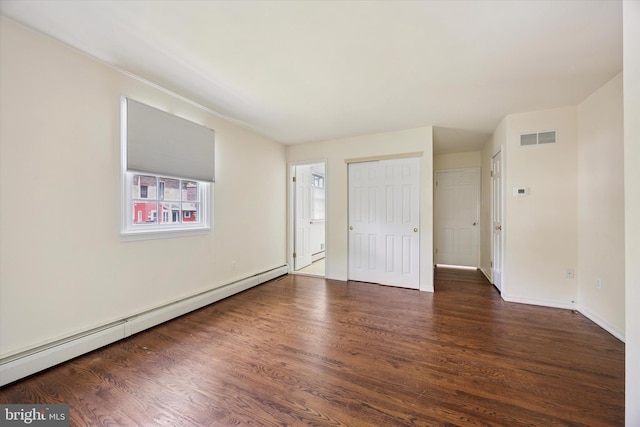 151 W Meade St, Philadelphia, PA 19118 - unfurnished bedroom featuring baseboard heating, wood finished floors, and baseboards