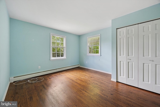151 W Meade St, Philadelphia, PA 19118 - unfurnished bedroom featuring a baseboard heating unit, wood finished floors, baseboards, and a closet