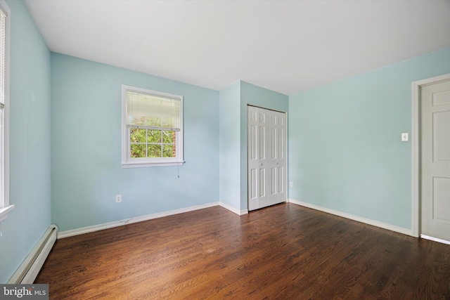 151 W Meade St, Philadelphia, PA 19118 - unfurnished bedroom with a baseboard heating unit, wood finished floors, baseboards, and a closet