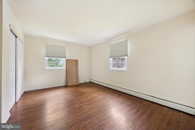 151 W Meade St, Philadelphia, PA 19118 - unfurnished bedroom featuring baseboard heating, wood finished floors, a closet, and baseboards