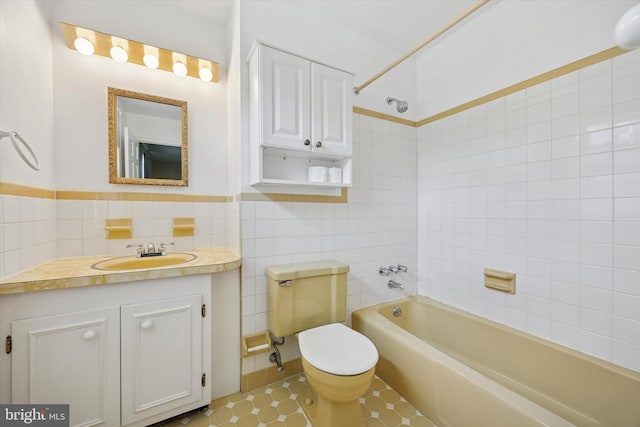 151 W Meade St, Philadelphia, PA 19118 - full bath with tile walls, toilet, shower / bathtub combination, and vanity