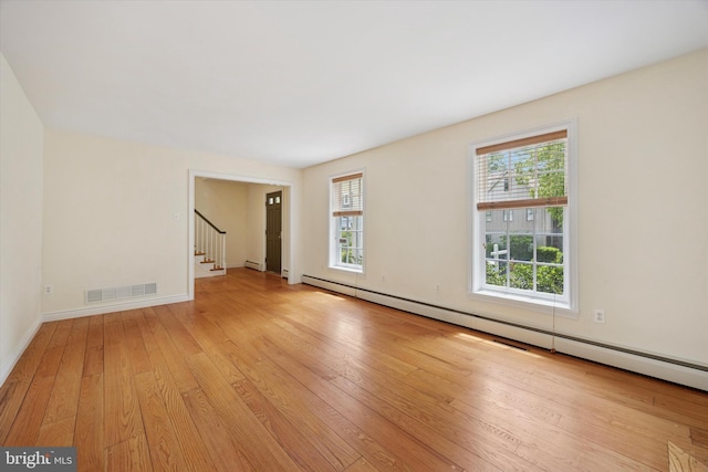151 W Meade St, Philadelphia, PA 19118 - empty room featuring a baseboard radiator, light wood finished floors, stairs, and baseboards