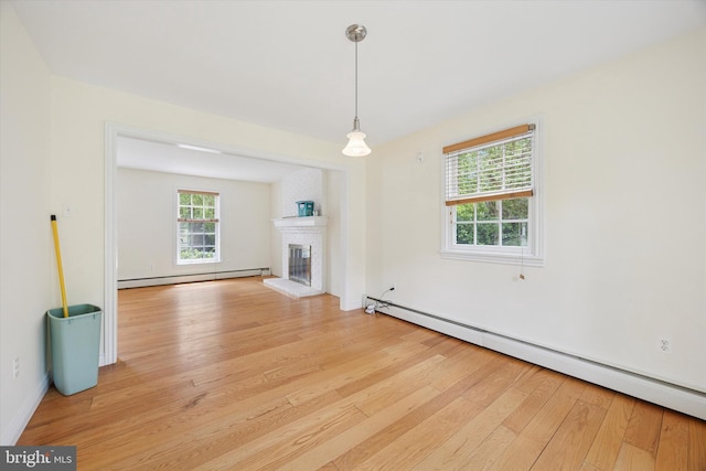 151 W Meade St, Philadelphia, PA 19118 - unfurnished living room featuring a baseboard radiator, a baseboard heating unit, light wood finished floors, a fireplace, and baseboards
