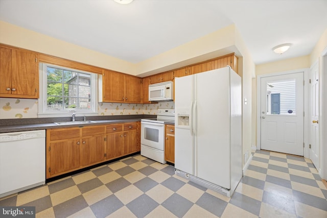 151 W Meade St, Philadelphia, PA 19118 - kitchen featuring white appliances, a sink, light floors, dark countertops, and brown cabinets