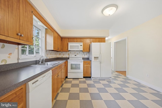 151 W Meade St, Philadelphia, PA 19118 - kitchen with white appliances, a sink, light flooring, brown cabinets, and dark countertops