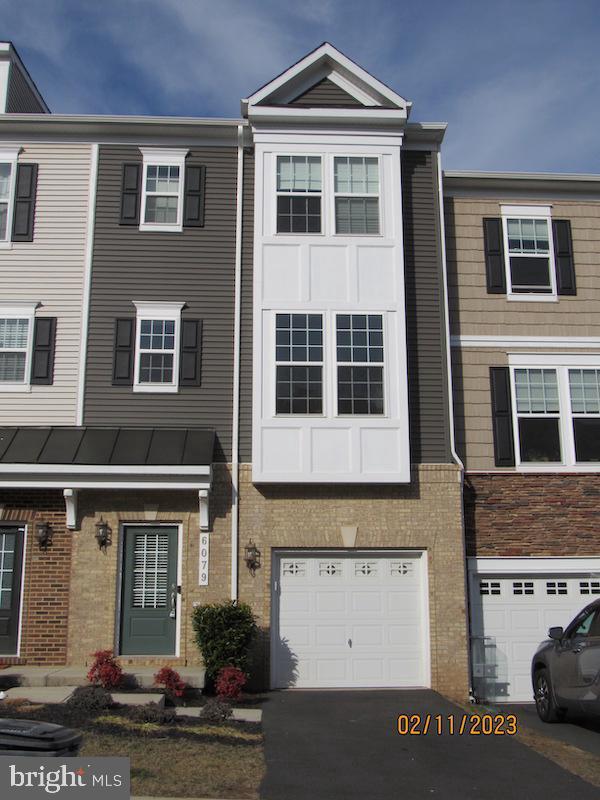 6079 Camerons Ferry Dr, Haymarket, VA 20169 - multi unit property featuring an attached garage, brick siding, and driveway