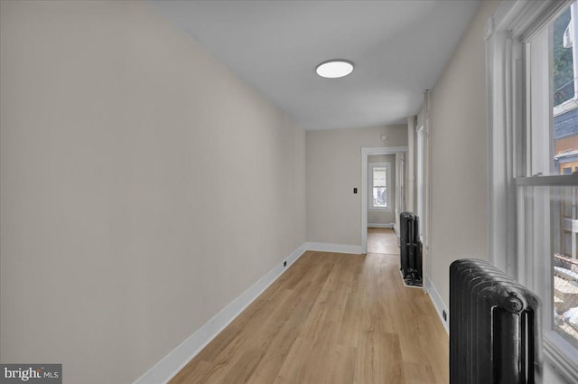 1120 N 10th St, Reading, PA 19604 - hall with radiator heating unit, light wood finished floors, and baseboards