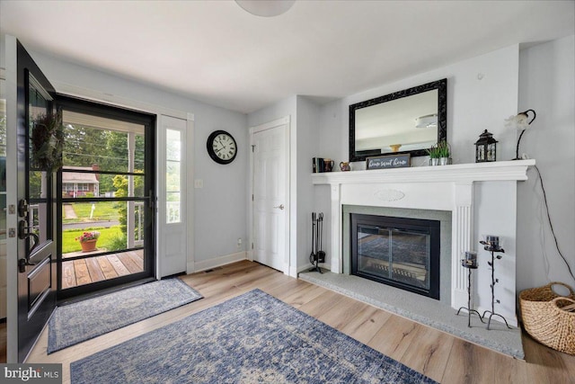 209 Burlington Ave, Voorhees, NJ 08043 - entryway with wood finished floors, a glass covered fireplace, and baseboards