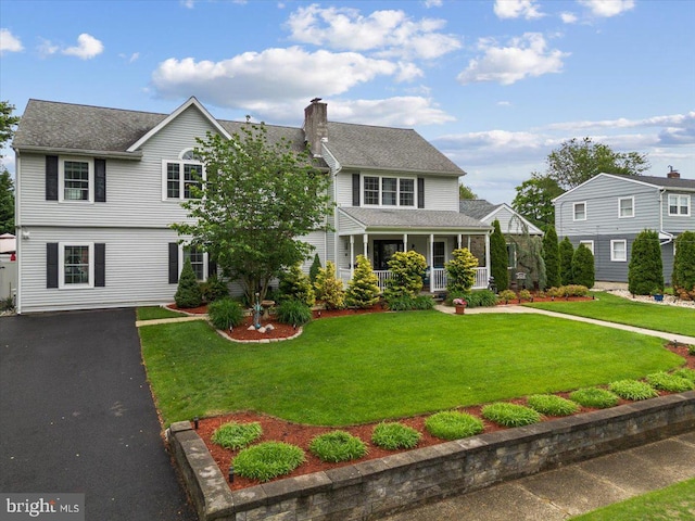 209 Burlington Ave, Voorhees, NJ 08043 - view of front facade featuring a chimney, covered porch, a front lawn, and driveway