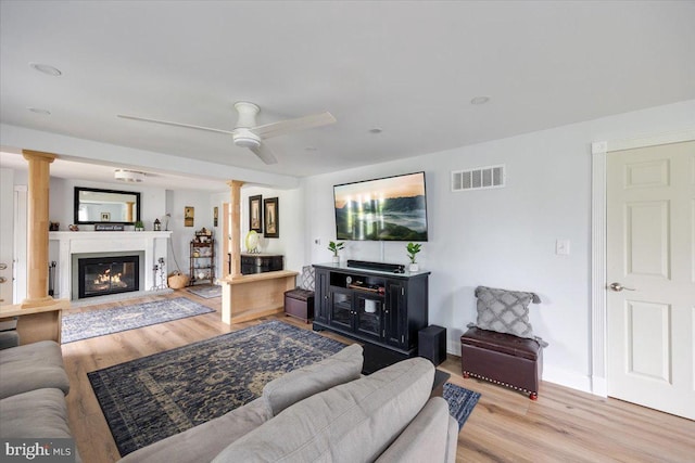 209 Burlington Ave, Voorhees, NJ 08043 - living area with ornate columns, wood finished floors, ceiling fan, and a fireplace with flush hearth