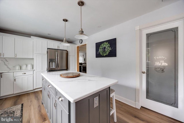 209 Burlington Ave, Voorhees, NJ 08043 - kitchen with stainless steel fridge with ice dispenser, a center island, wood finished floors, and decorative light fixtures