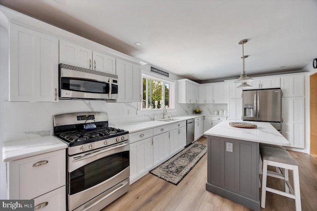 209 Burlington Ave, Voorhees, NJ 08043 - kitchen featuring appliances with stainless steel finishes, a sink, light wood-style flooring, white cabinetry, and recessed lighting