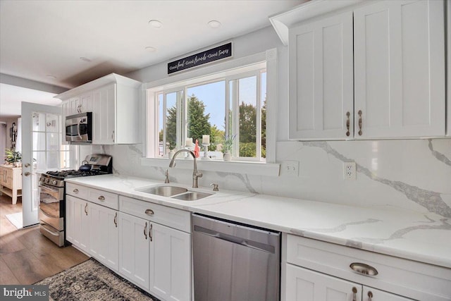 209 Burlington Ave, Voorhees, NJ 08043 - kitchen with appliances with stainless steel finishes, a sink, white cabinets, wood finished floors, and light stone countertops