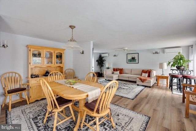 209 Burlington Ave, Voorhees, NJ 08043 - dining area with an AC wall unit, ceiling fan, light wood-type flooring, and a wall mounted AC