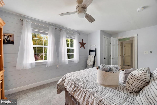 209 Burlington Ave, Voorhees, NJ 08043 - carpeted bedroom with baseboards, wooden walls, and ceiling fan