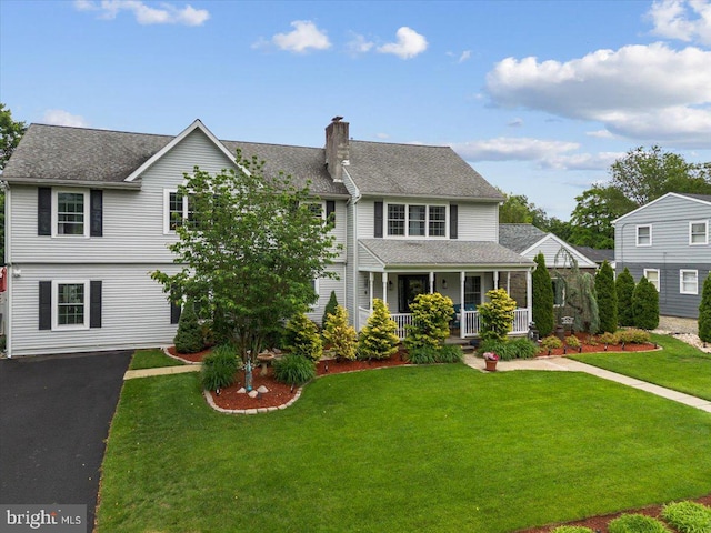 209 Burlington Ave, Voorhees, NJ 08043 - view of front of property with covered porch, a front lawn, a chimney, roof with shingles, and asphalt driveway