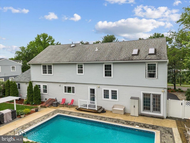 209 Burlington Ave, Voorhees, NJ 08043 - back of house with a patio, an outdoor pool, a shingled roof, and a gate