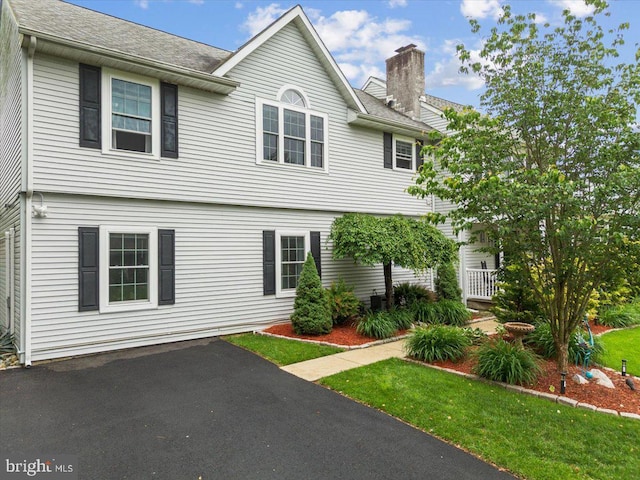 209 Burlington Ave, Voorhees, NJ 08043 - colonial-style house featuring a chimney, roof with shingles, and a front yard