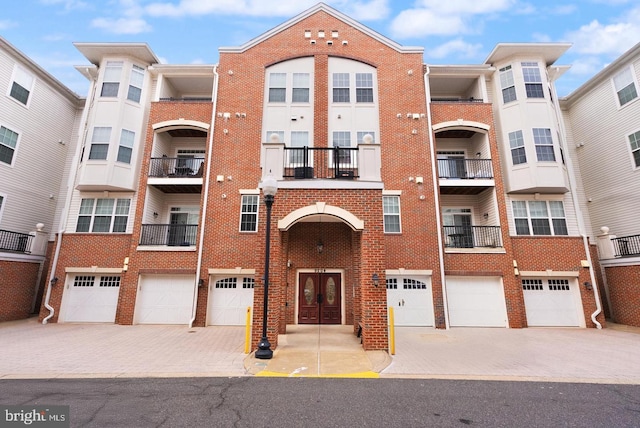 9204 Charleston Dr Unit 407, Manassas, VA 20110 - view of apartment building / complex featuring a garage and driveway