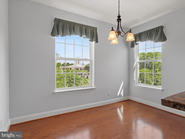 9204 Charleston Dr Unit 407, Manassas, VA 20110 - unfurnished room with a chandelier, wood finished floors, and baseboards