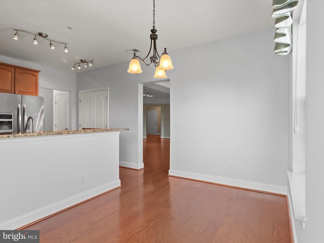 9204 Charleston Dr Unit 407, Manassas, VA 20110 - kitchen featuring stainless steel fridge, wood finished floors, a chandelier, baseboards, and brown cabinets