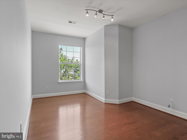 9204 Charleston Dr Unit 407, Manassas, VA 20110 - spare room with wood finished floors, baseboards, and rail lighting