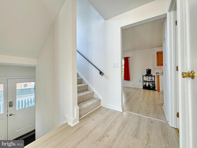 8565 E St, Chesapeake Beach, MD 20732 - entryway featuring light wood finished floors, stairs, baseboards, and vaulted ceiling