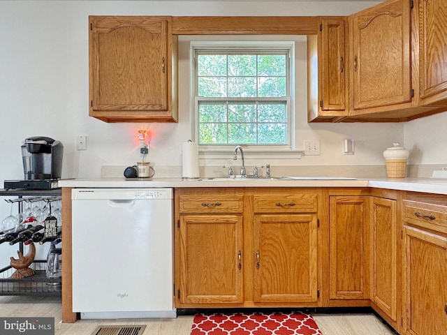 8565 E St, Chesapeake Beach, MD 20732 - kitchen featuring dishwasher, a sink, and light countertops