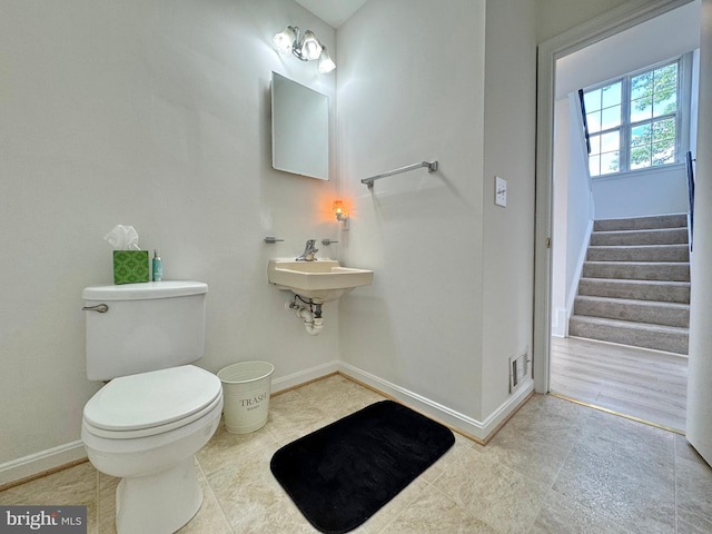 8565 E St, Chesapeake Beach, MD 20732 - bathroom with toilet, baseboards, tile patterned floors, and a sink