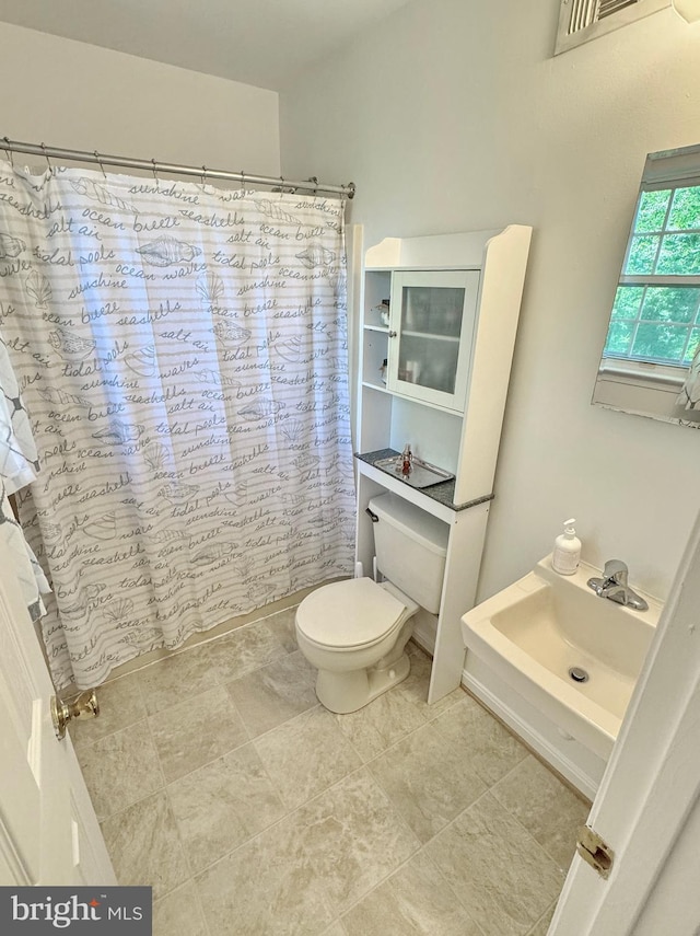8565 E St, Chesapeake Beach, MD 20732 - bathroom featuring toilet and curtained shower