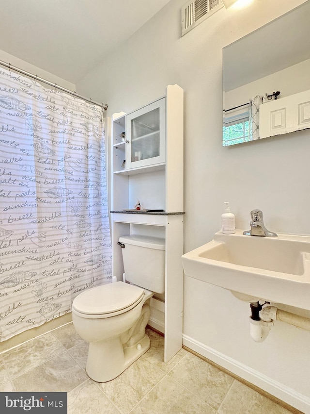 8565 E St, Chesapeake Beach, MD 20732 - bathroom with toilet, curtained shower, and tile patterned floors