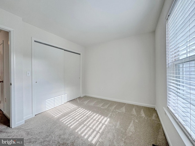 8565 E St, Chesapeake Beach, MD 20732 - unfurnished bedroom featuring light carpet, a closet, and baseboards