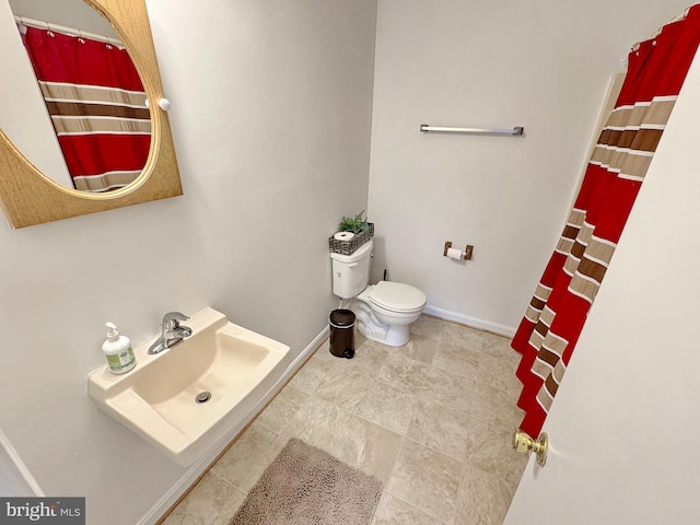 8565 E St, Chesapeake Beach, MD 20732 - full bathroom with a sink, toilet, and baseboards